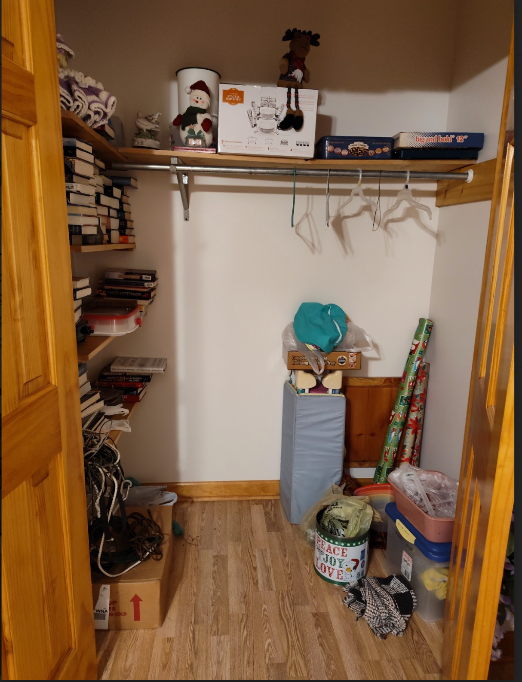 A closet filled with lots of boxes and clothes