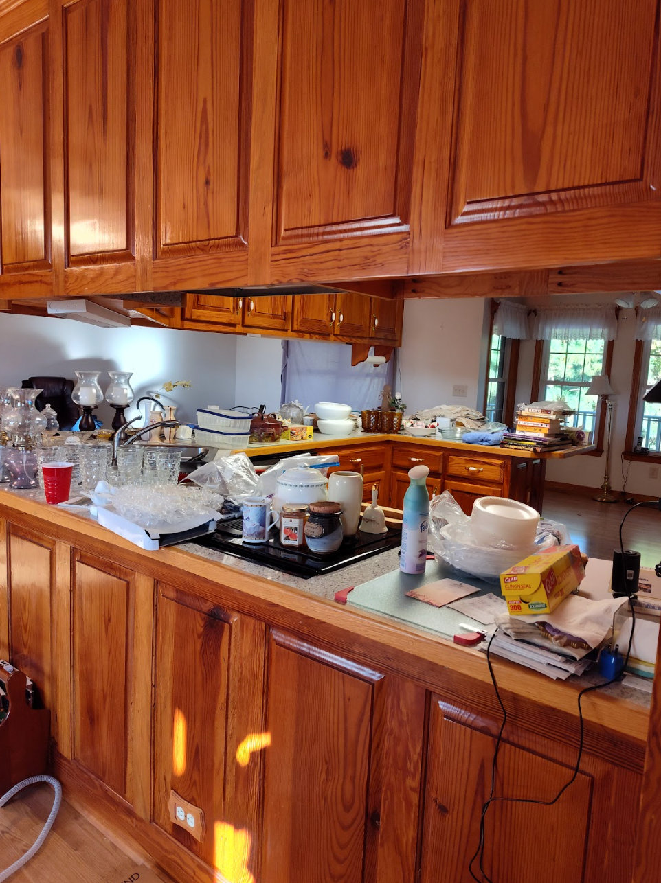 A kitchen with wooden cabinets and a stove top oven.