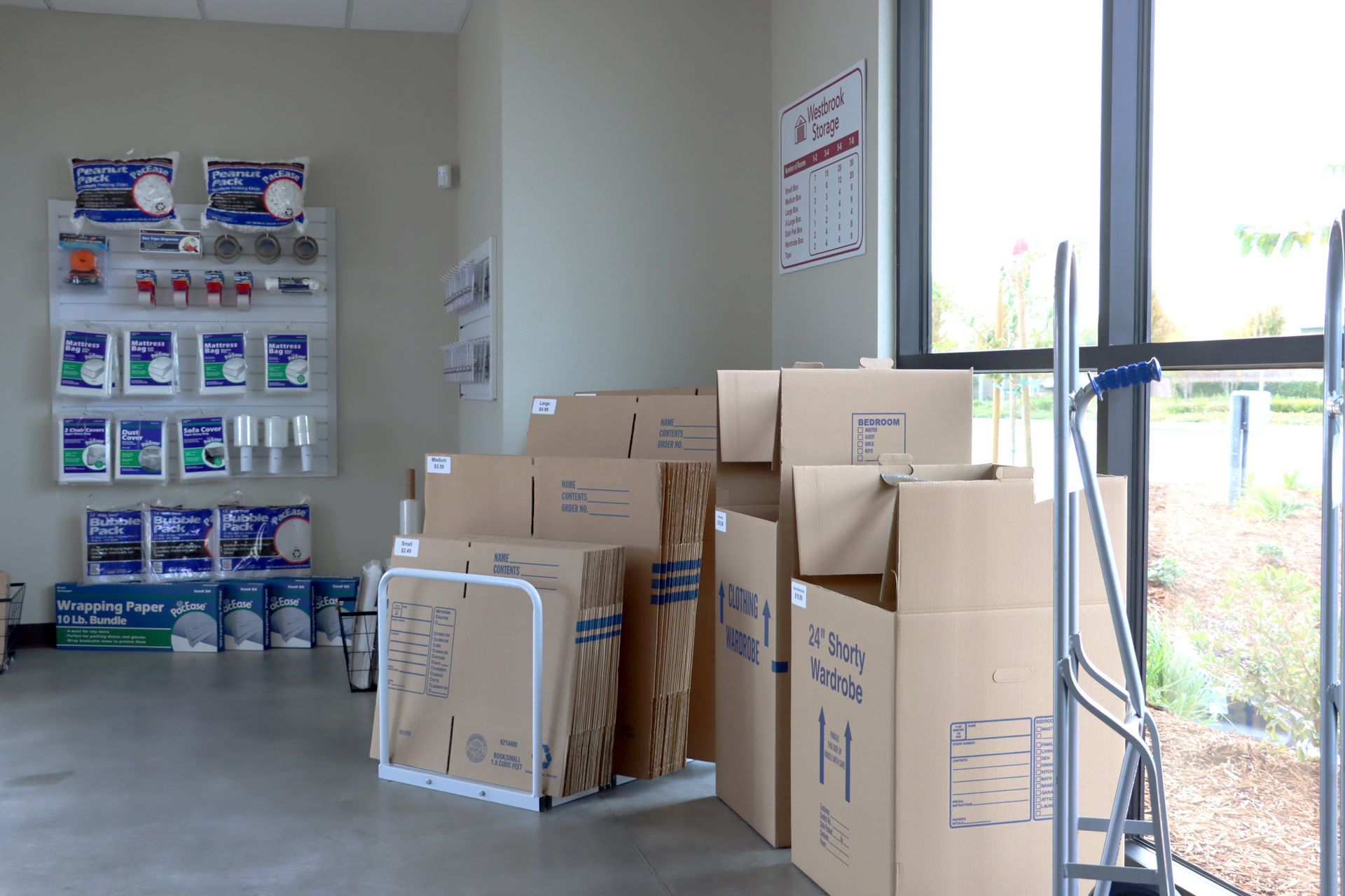 A room filled with boxes and a hand truck