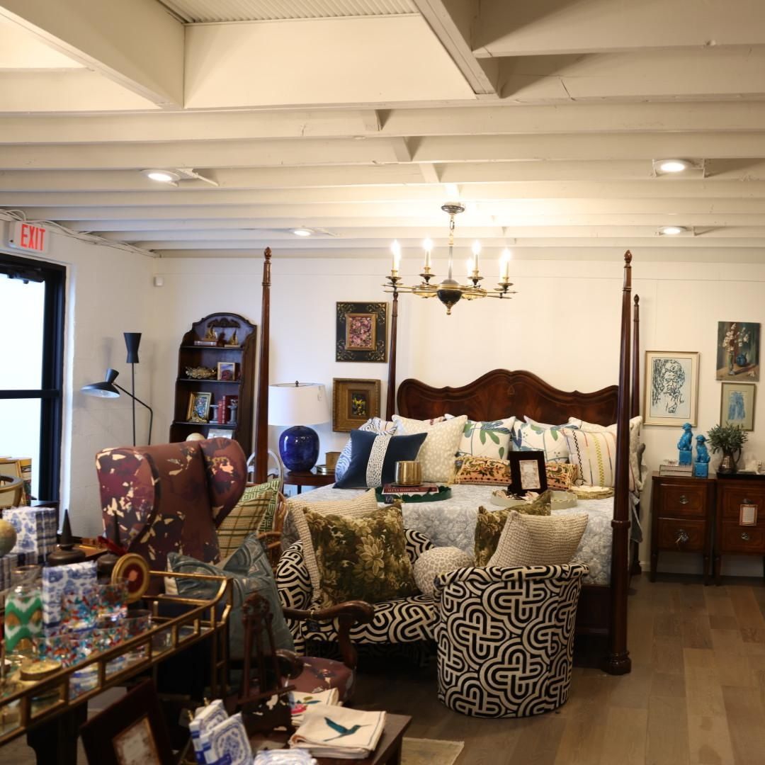A living room with a four poster bed and a couch