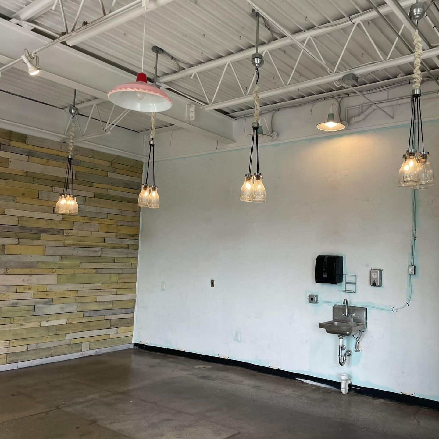An empty room with a sink hanging from the ceiling