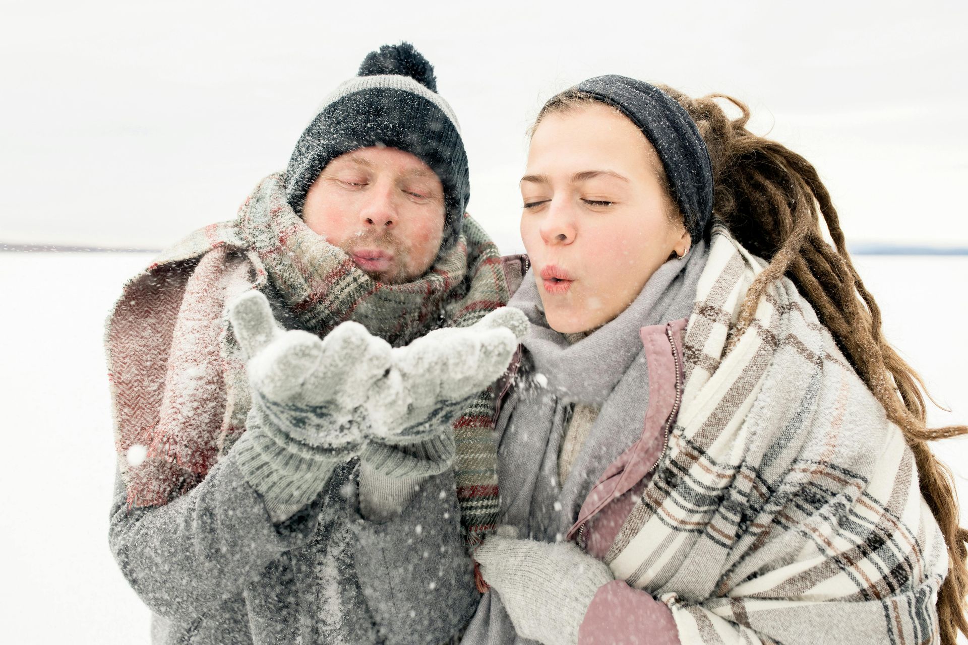 a couple of people enjoying winter