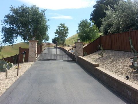 Man Screws Metal Fence — San Leandro, CA — AJR Door Service