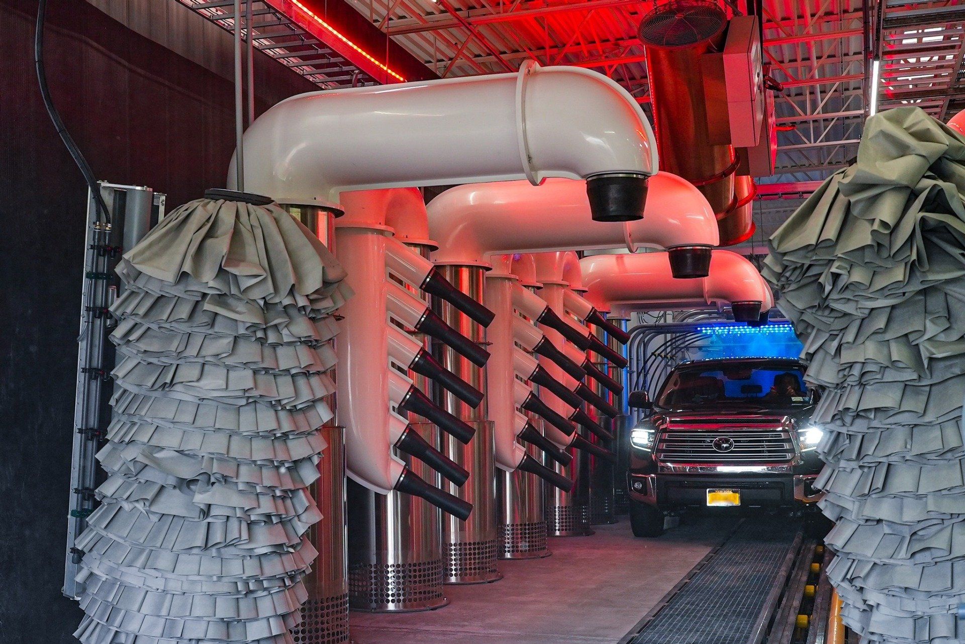 inside of a car wash showing the dryers and polishing brushes