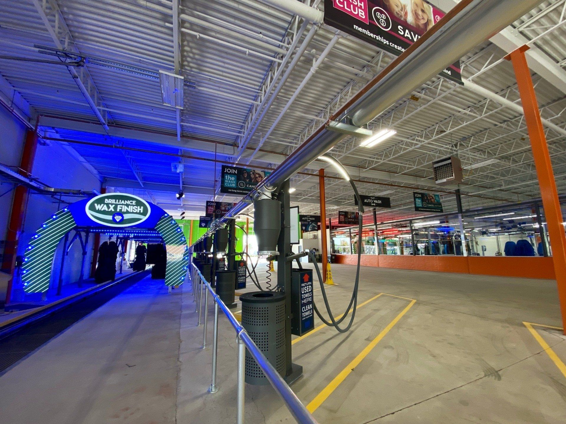 A large building with a lot of signs on the ceiling.
