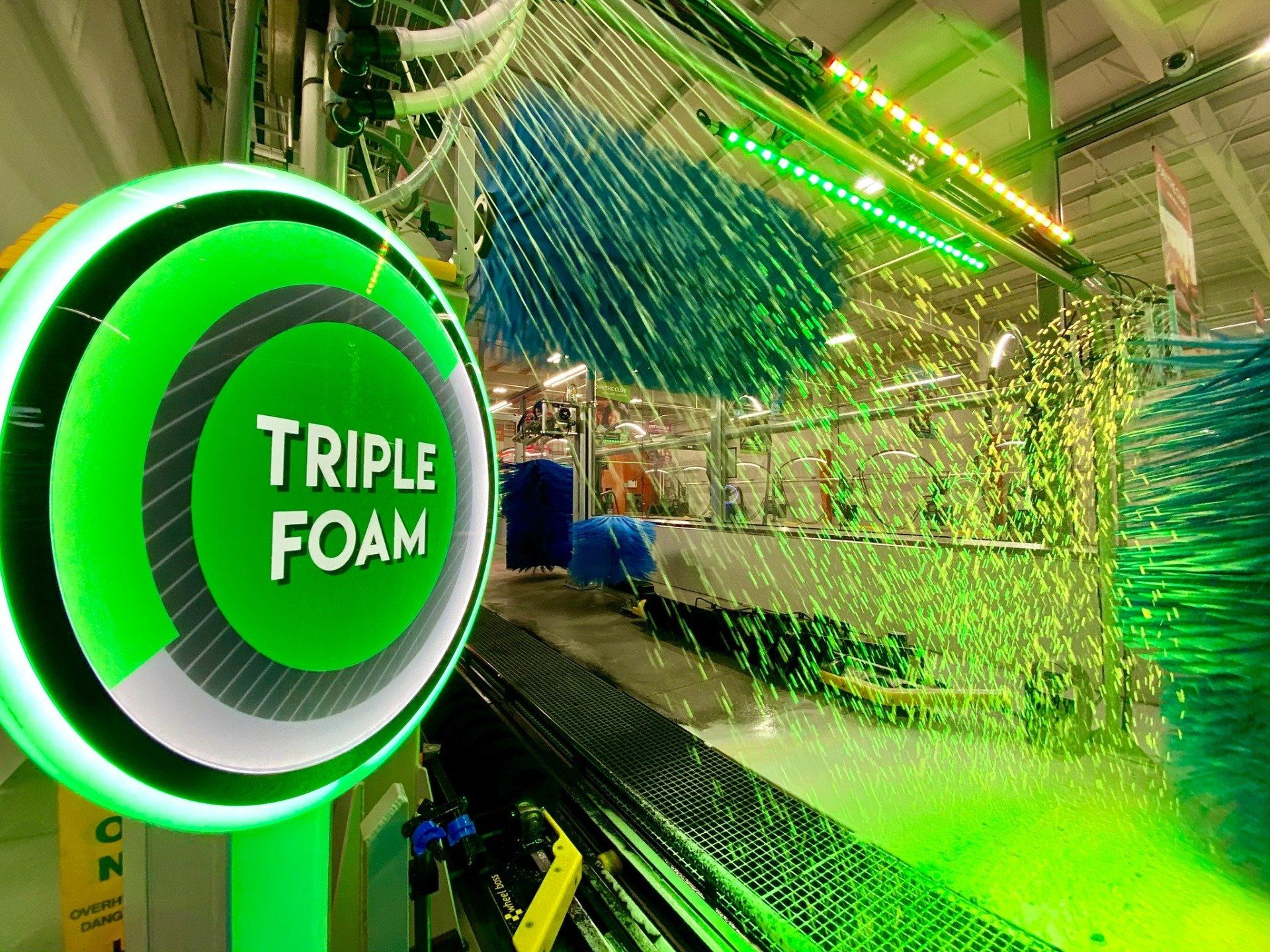 inside a green car wash with a sign that says 