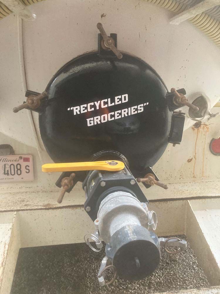 A black container with the words `` recycled groceries '' written on it.