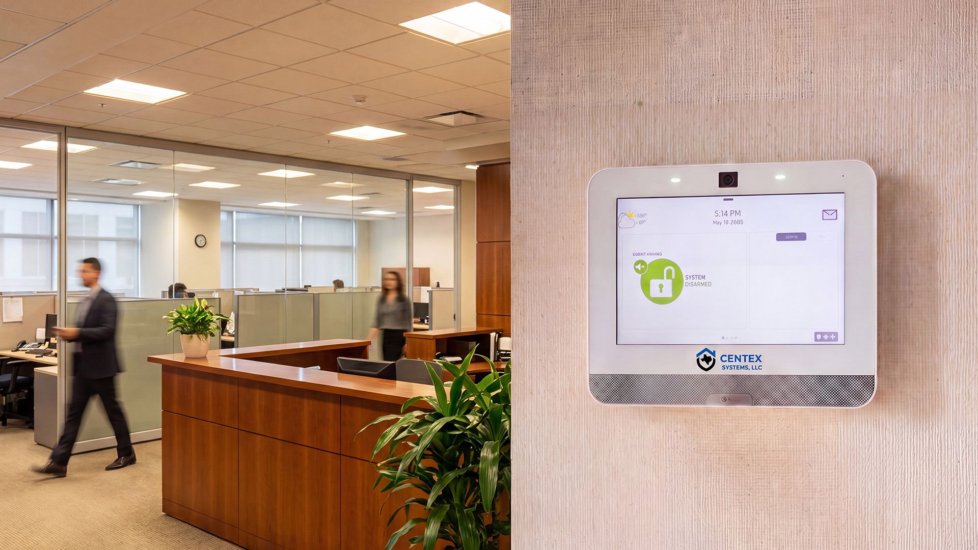 Modern office lobby with a wall-mounted thermostat control panel on the right