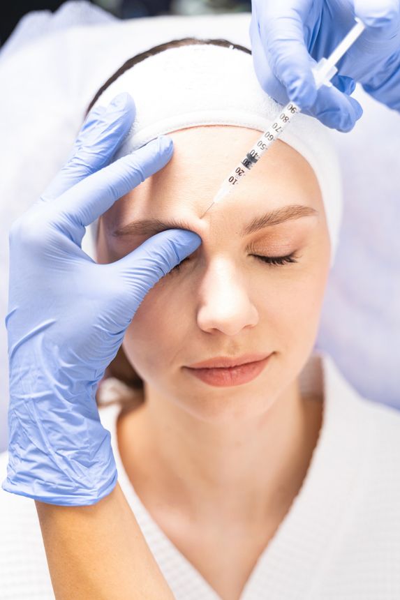 Woman getting dermal filler in forehead