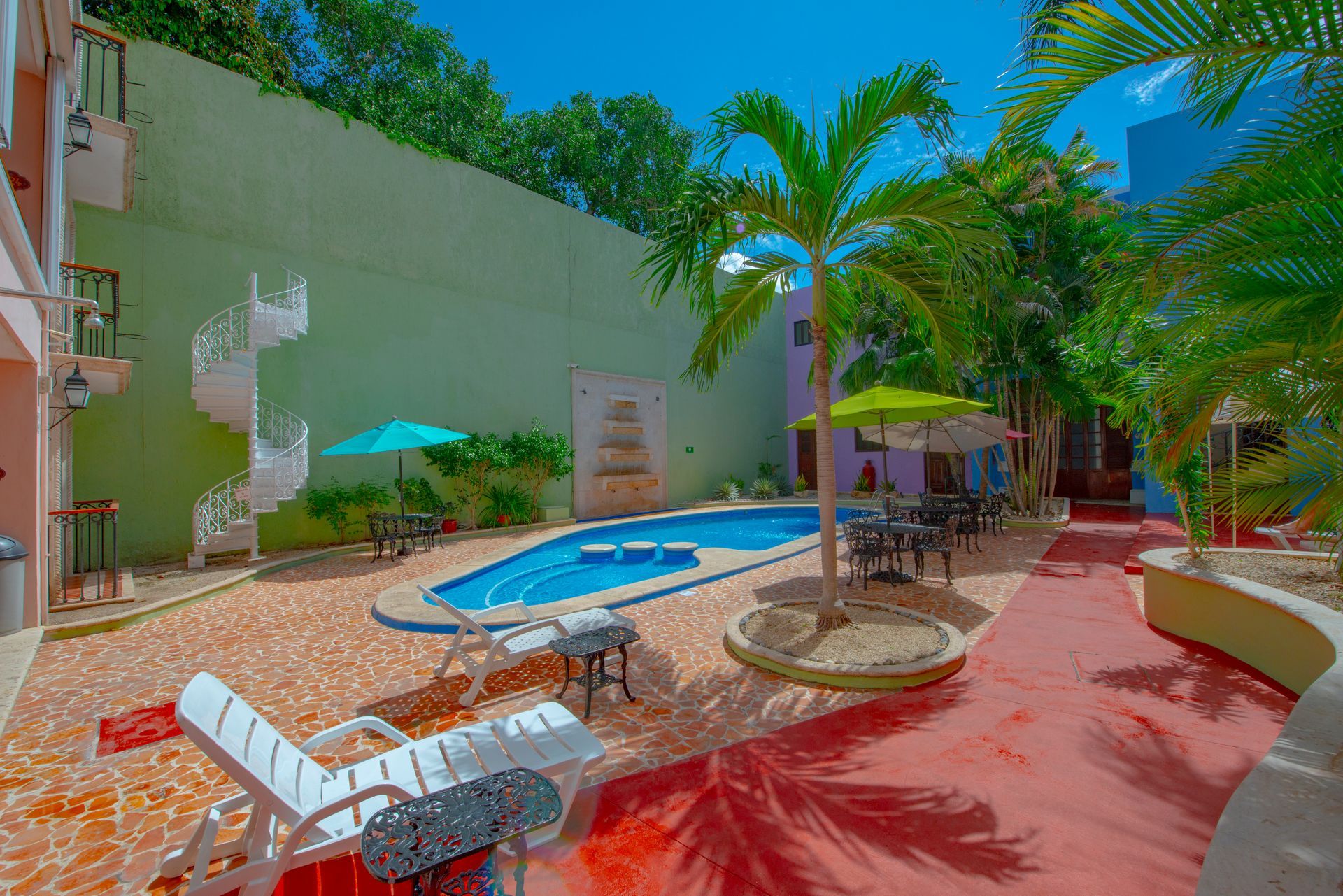 There is a large swimming pool in the middle of the courtyard.