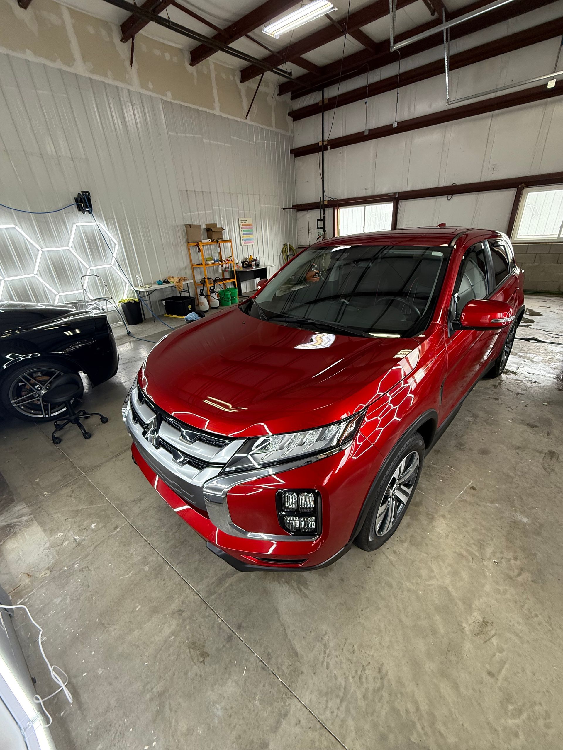 Red SUV auto detailing and polishing in Antioch IL by Captain Coles Detailing.