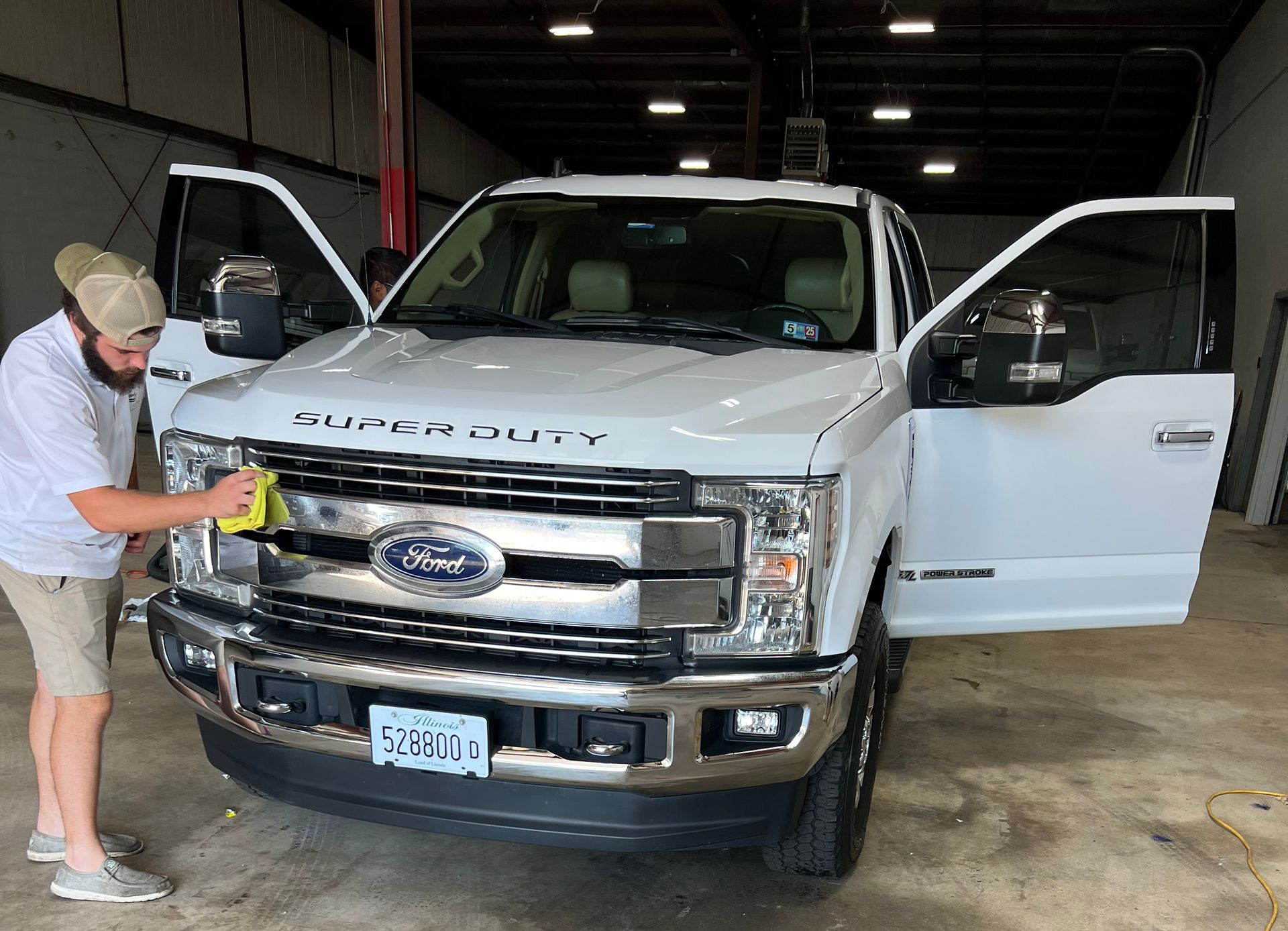 Engine bay detailing maintenance on white truck