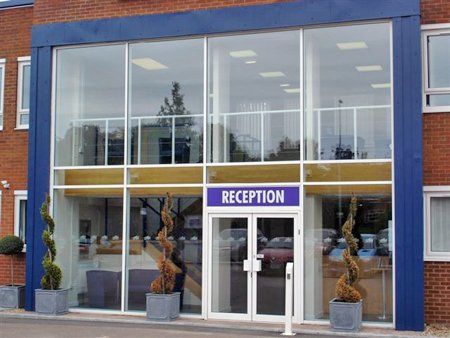 Glass fronted structure with twin doors leading to reception area