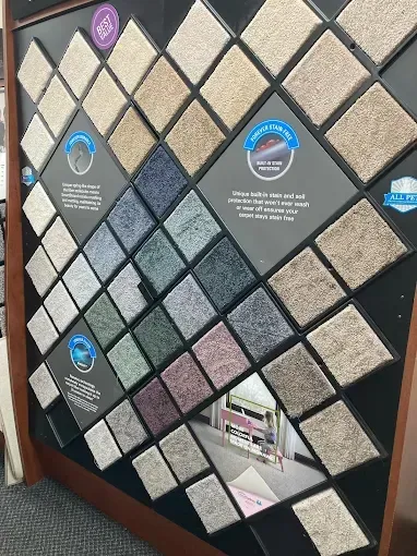 Carpet samples arranged on a display board, showcasing various textures and colors.