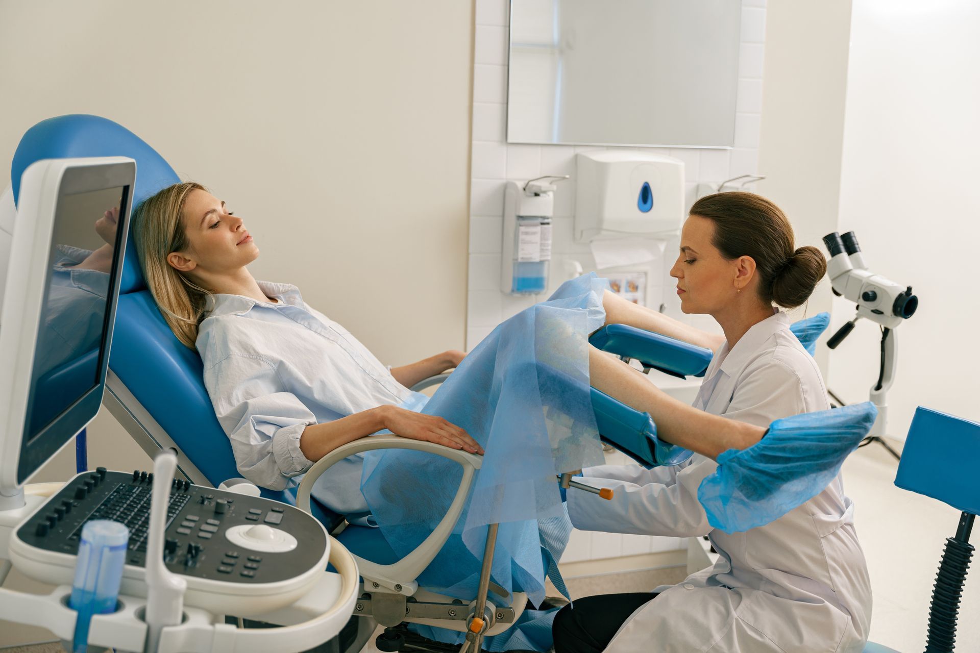 A woman is getting checked by a gynecologist.