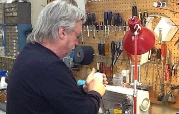 Man Checking on a Sewing Machine — Fredericksburg, VA — A Stitch In Time