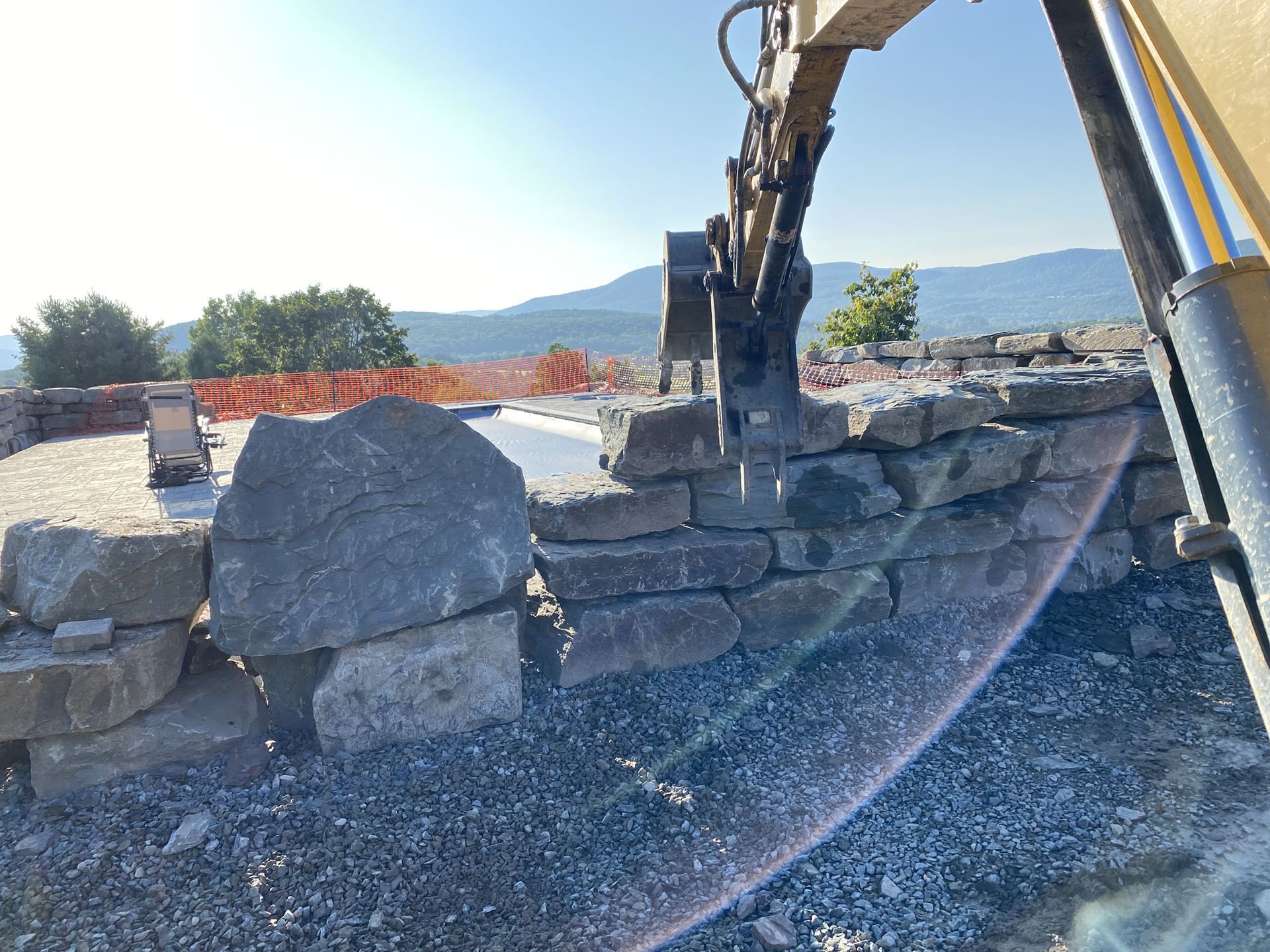 A bulldozer is digging a hole in a rock wall.