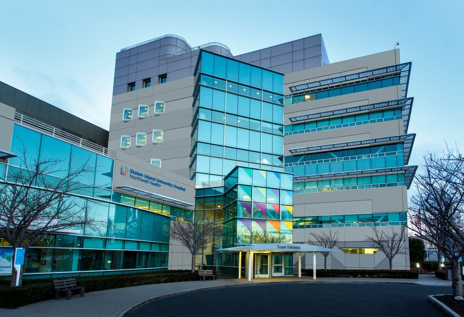 A large building with a lot of windows and trees in front of it