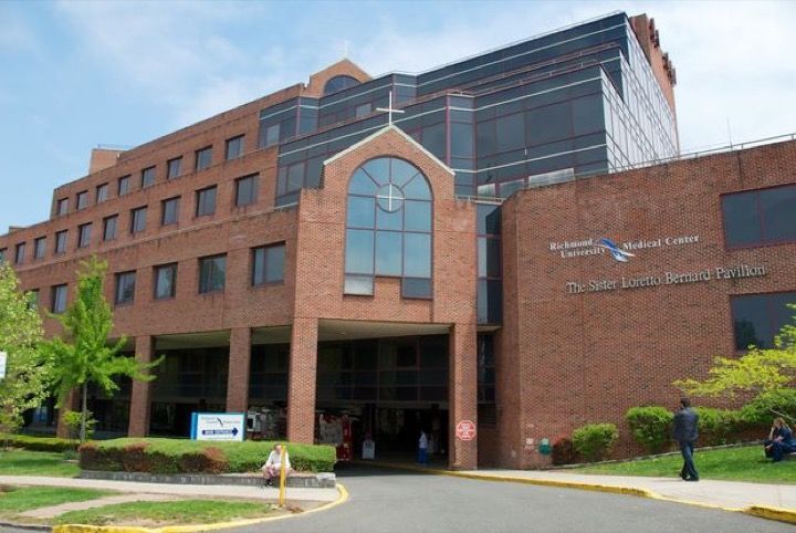 A large brick building with a cross on the top of it