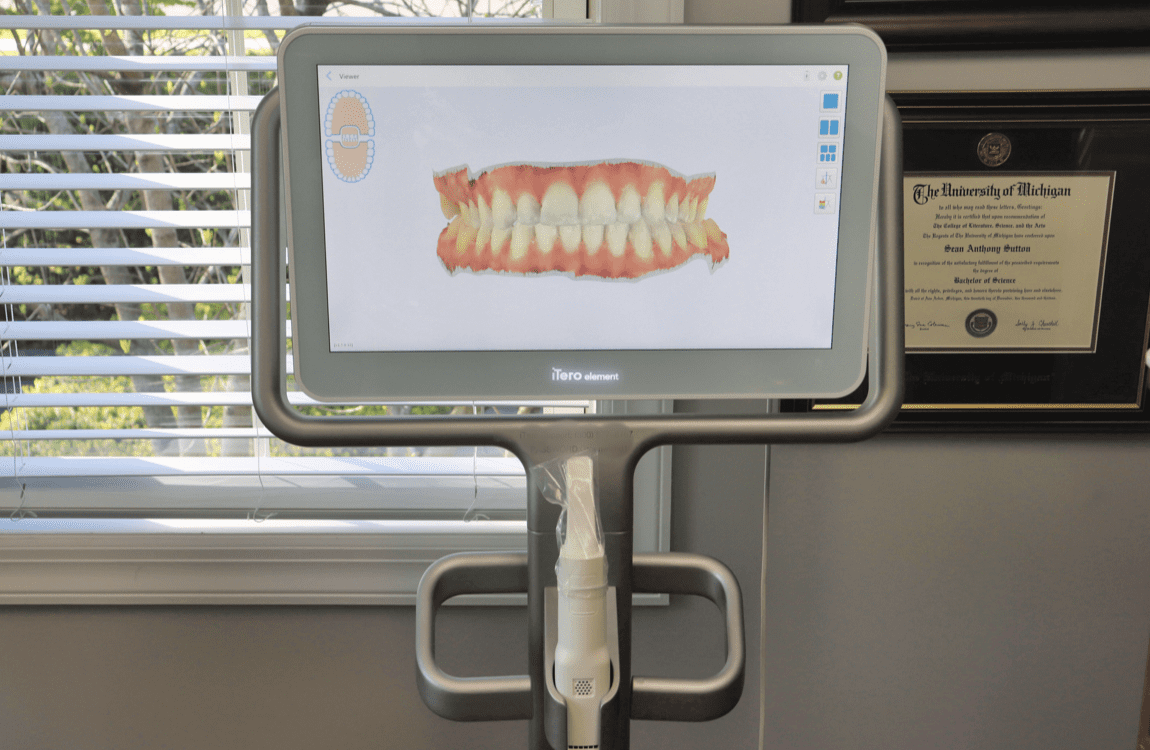 A computer monitor is sitting in front of a window in a dental office