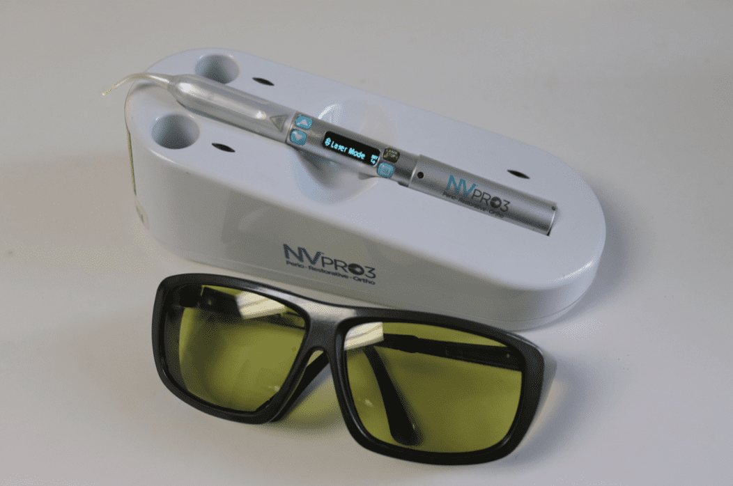 A pair of glasses next to a device that says nv11 on it