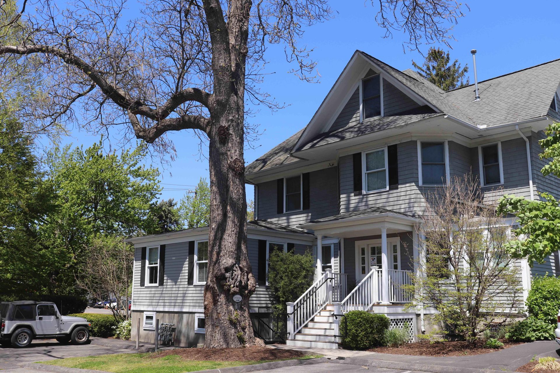 A large house with a large tree in front of it