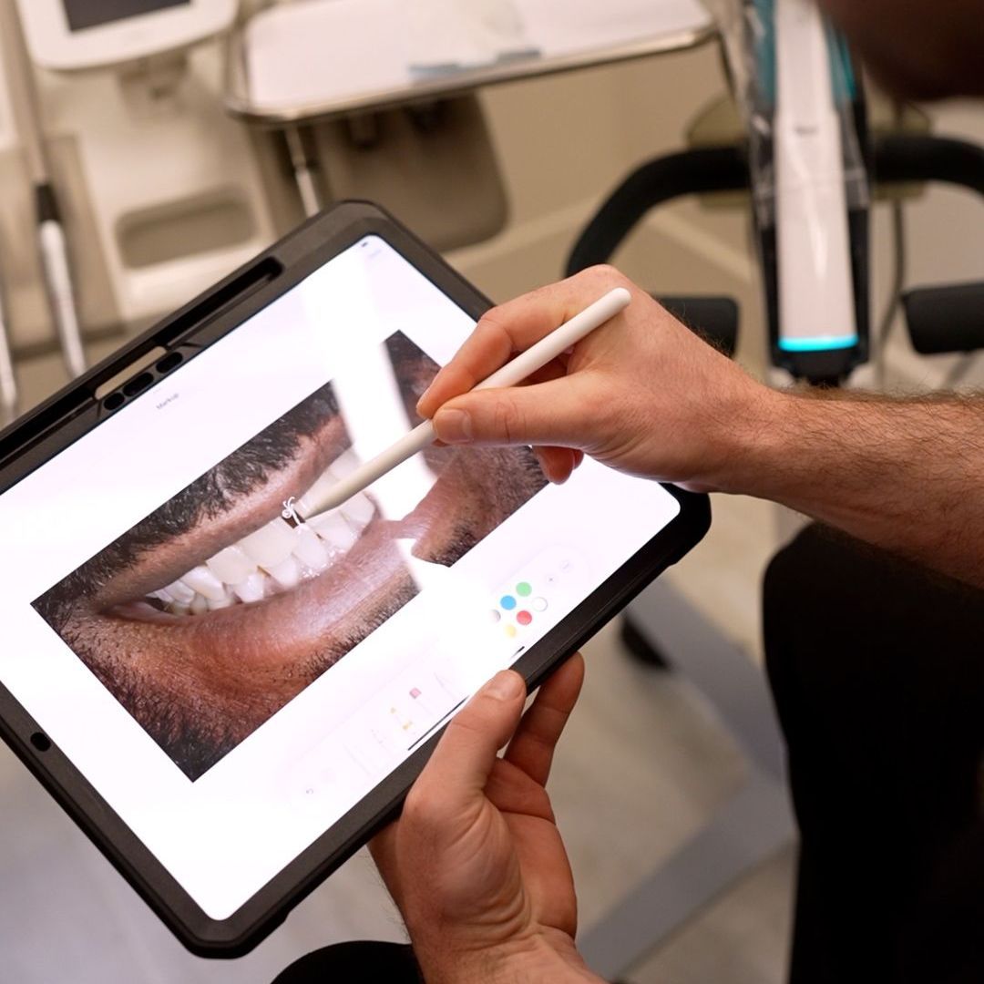 A person is holding a tablet with a pen in their hand