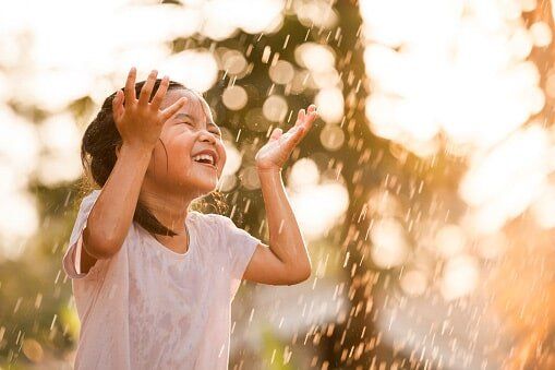 Little Girl Having Fun to Play with The Rain — Child Care in Rock Island, IL