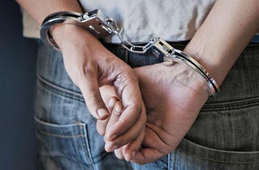 Man in handcuffs - Criminal Attorney in Saint Johns, MI