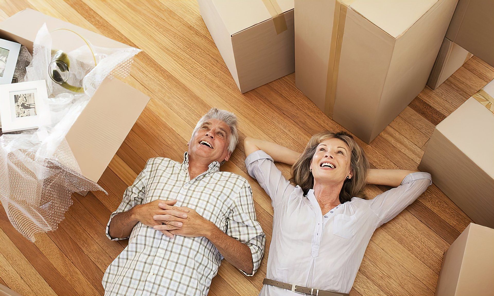 couple relaxing with moving boxes