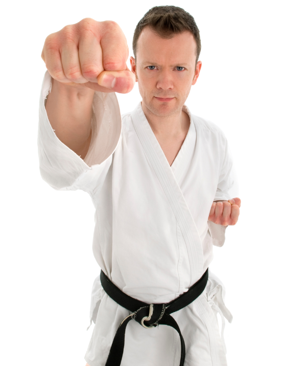 A man in a white karate uniform with a black belt is making a fist