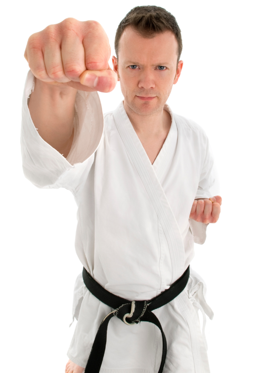 A man in a white karate uniform with a black belt is making a fist