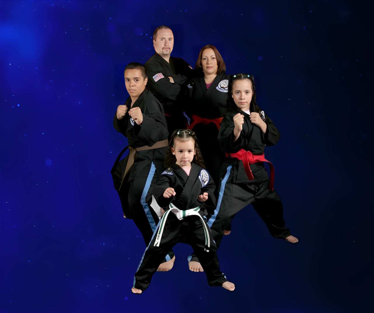 A group of people in karate uniforms are posing for a picture.