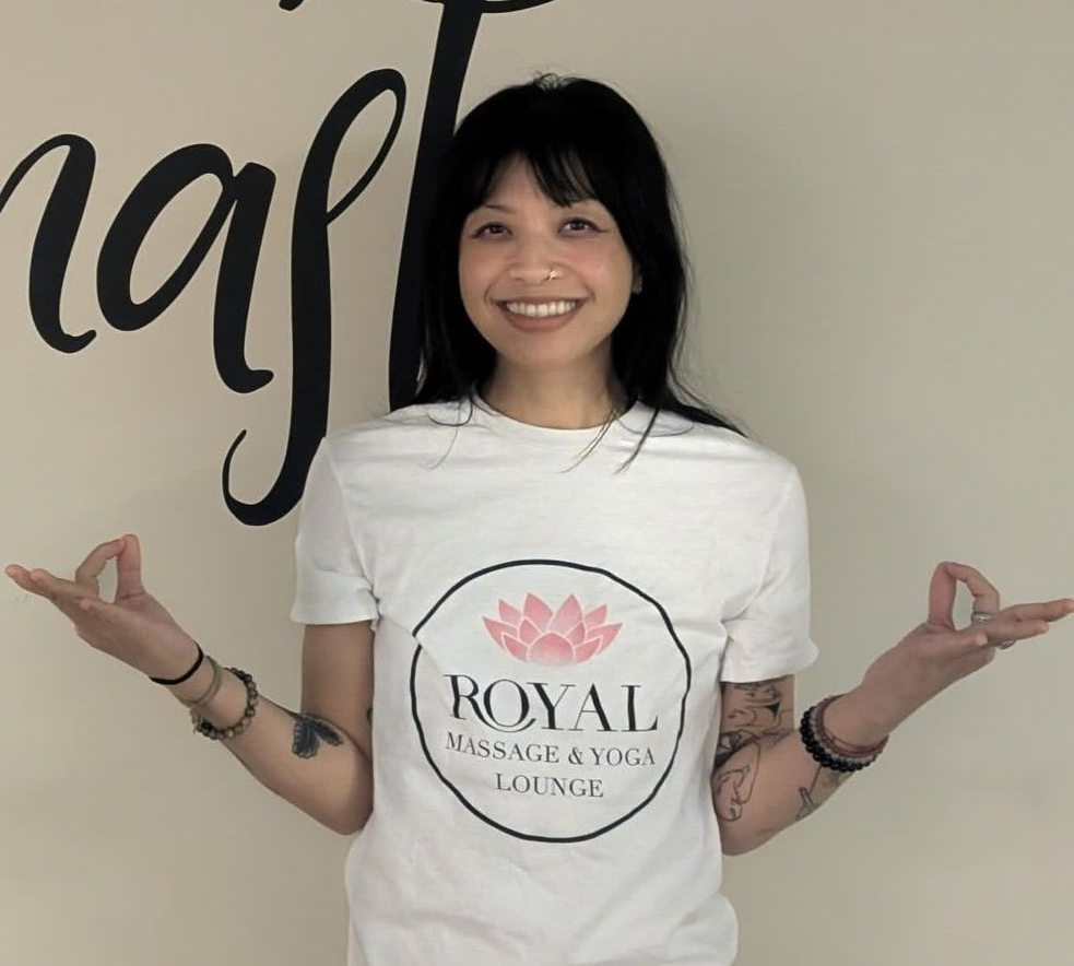 A smiling person wearing a white 