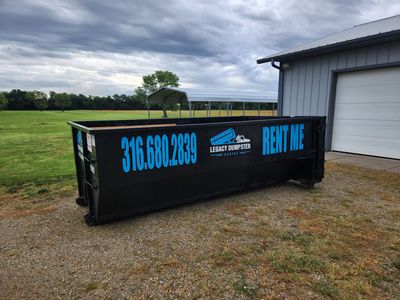 A 15 yard dumpster filled with trash to the top.