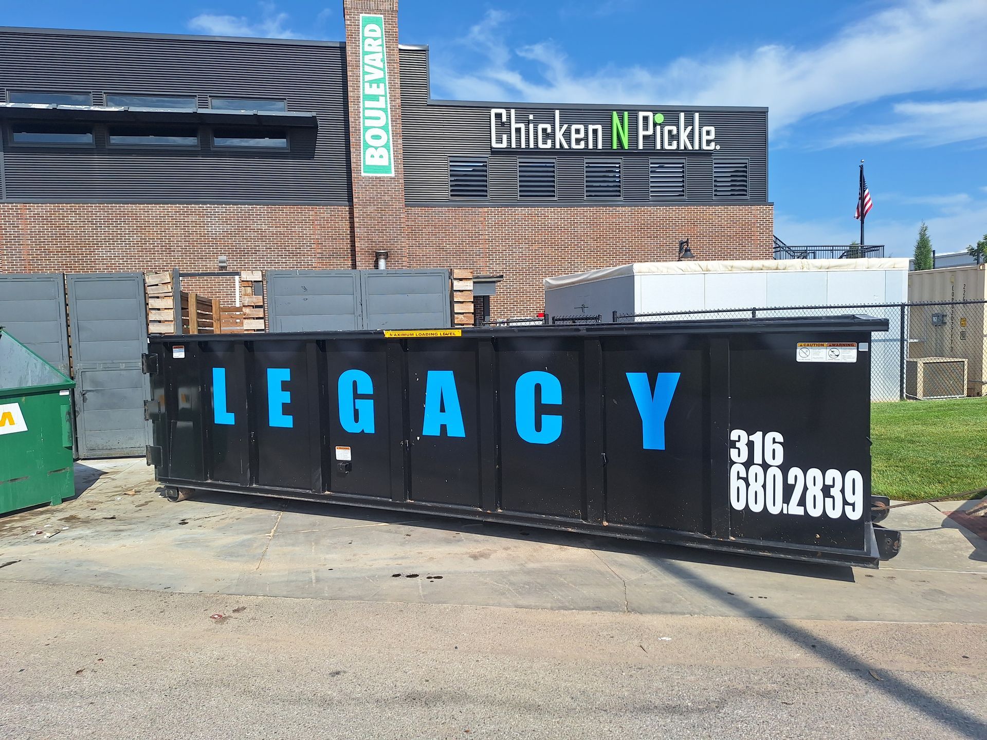 A dumpster with the word legacy on it