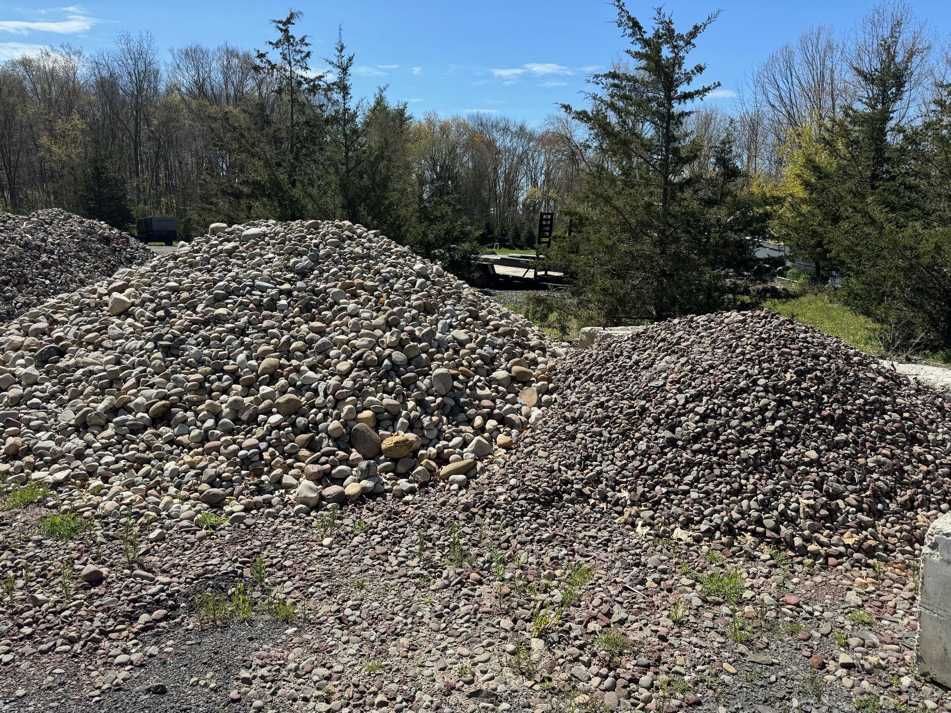 A large pile of rocks is sitting in the middle of a forest.