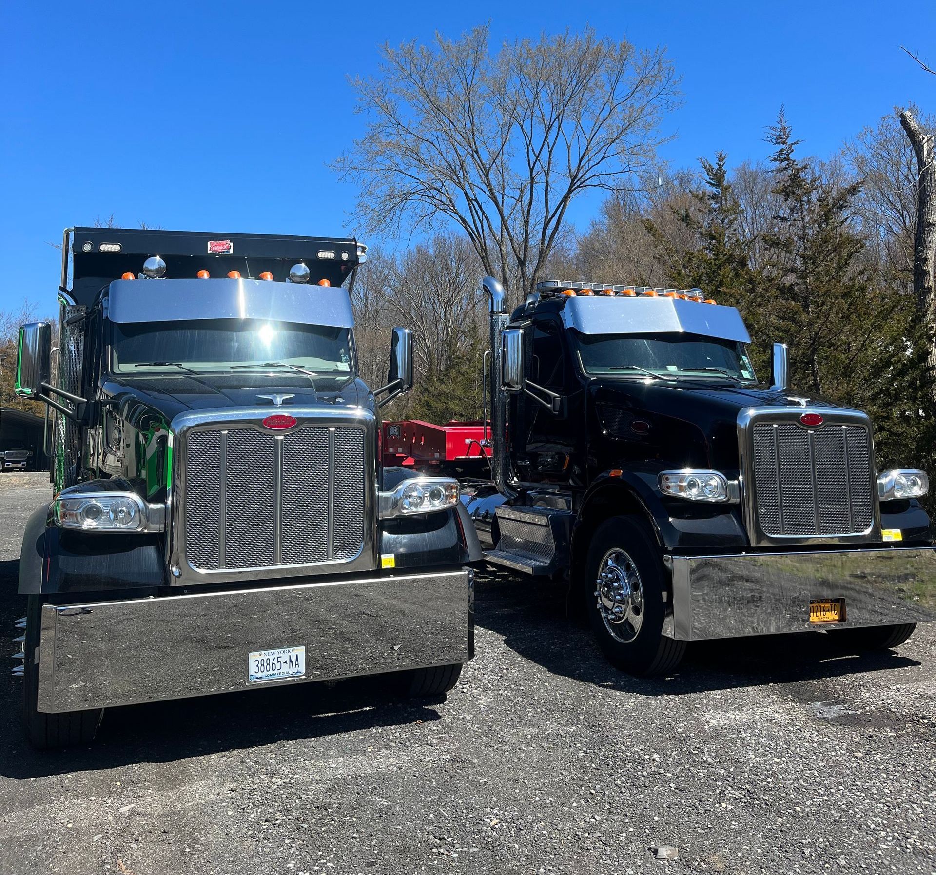 Two peterbilt semi trucks are parked next to each other