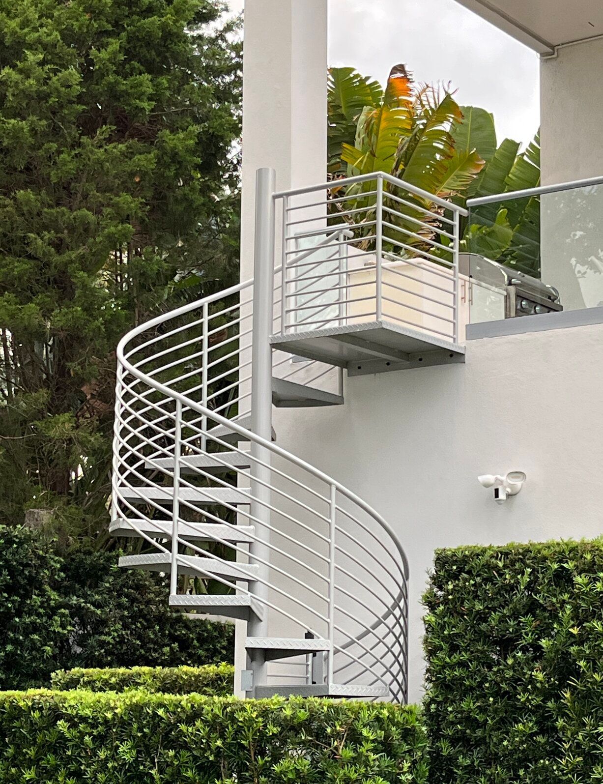 industrial modern silver spiral stairs at luxury residence in South Tampa