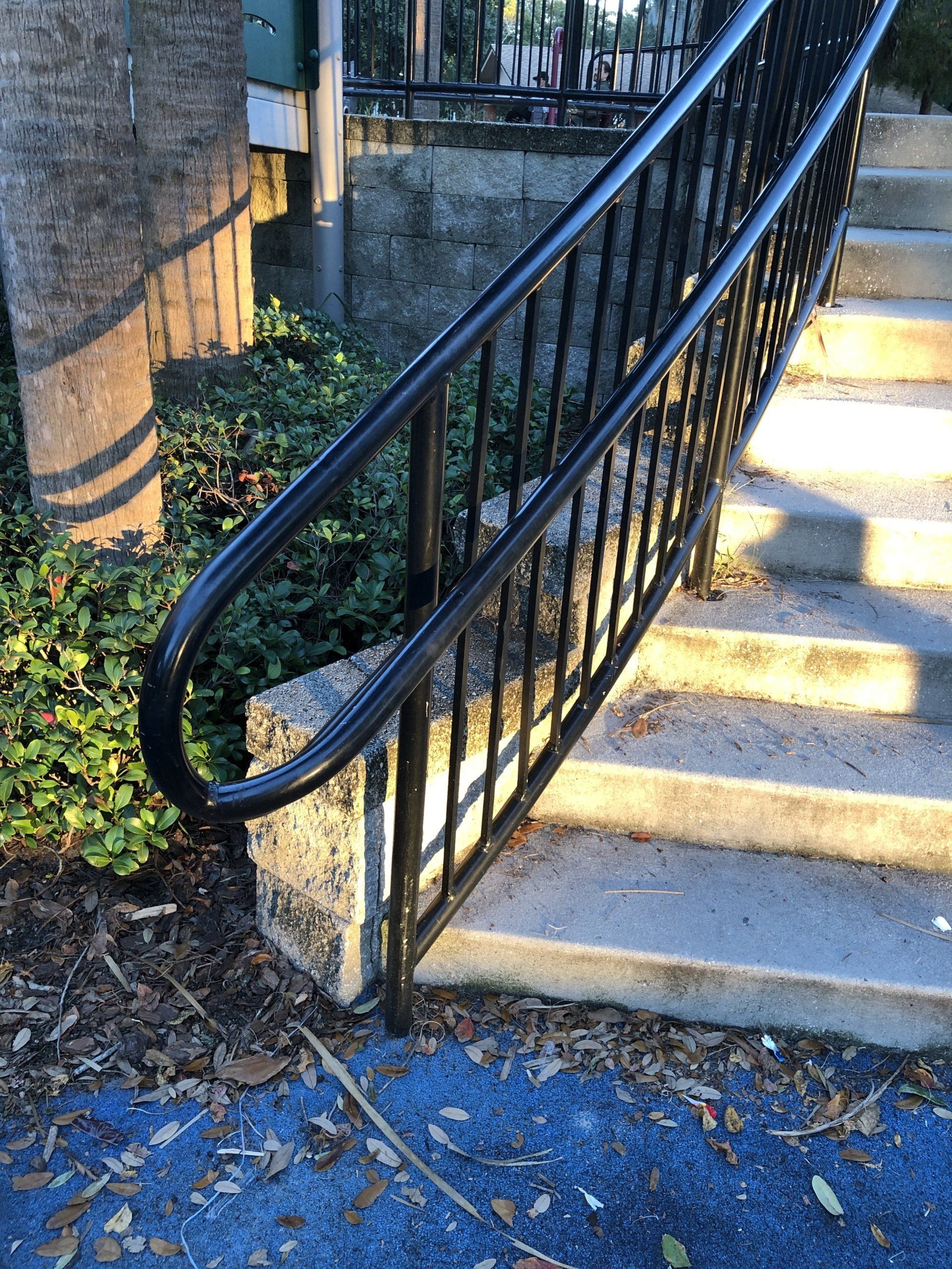 pipe handrail painted black at a playground in North Tampa