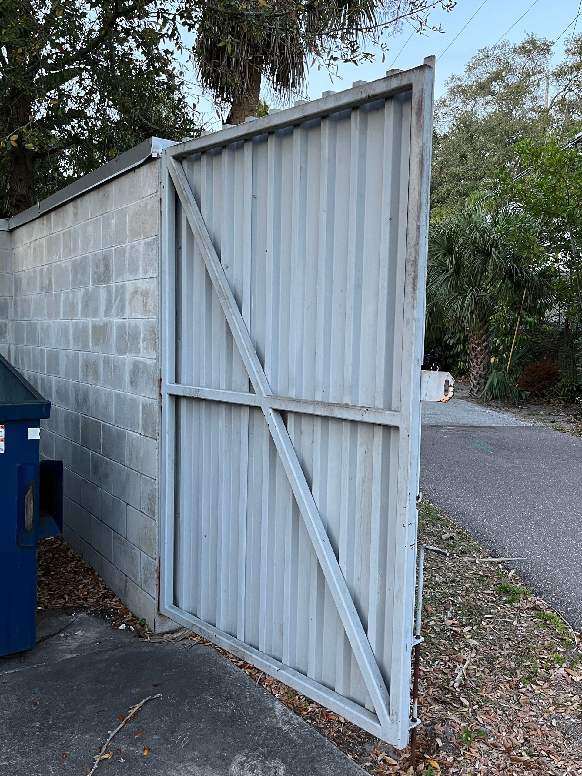 dumpster door installed on cinder block enclosure