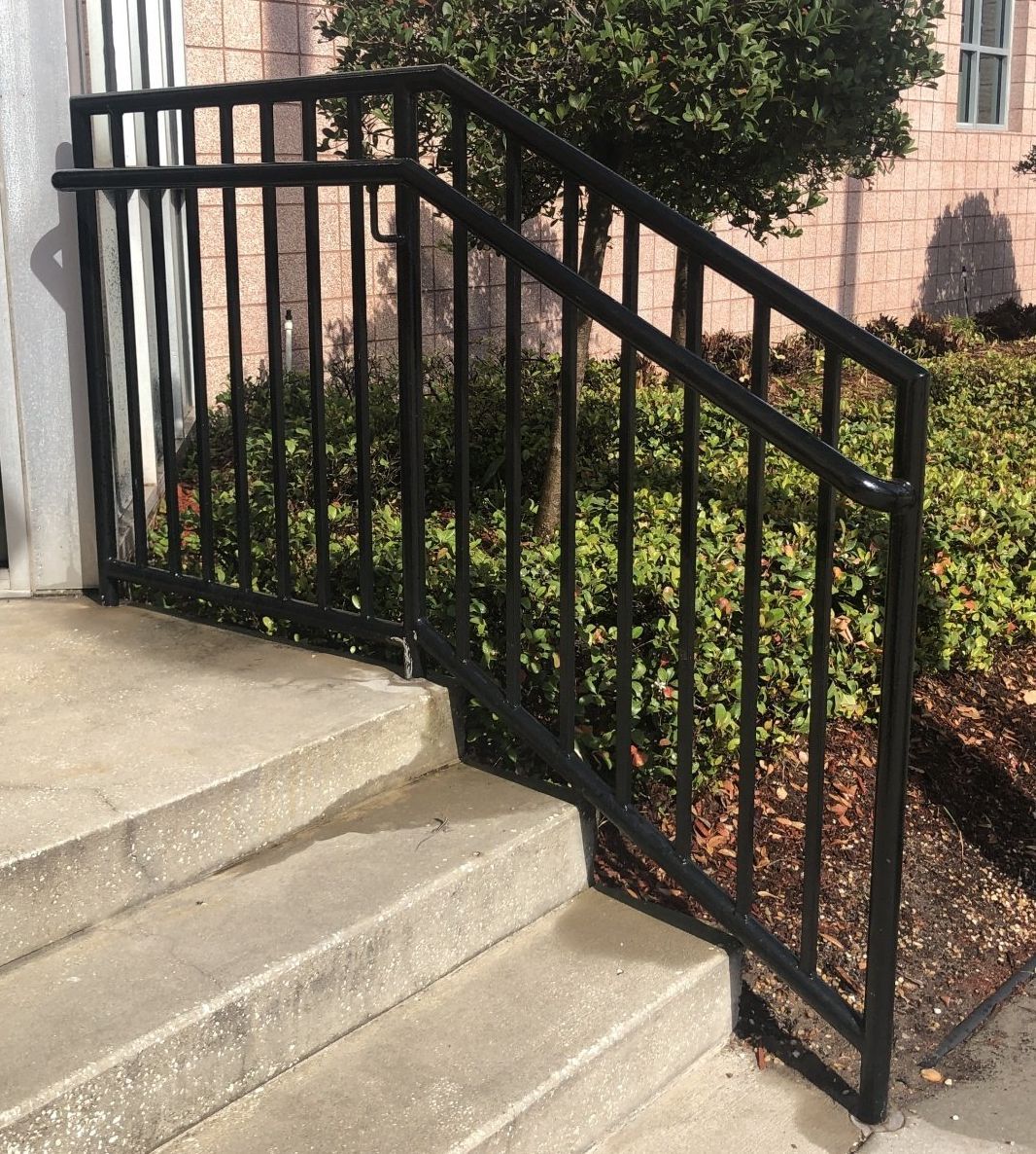 black 3 stair hand rail installed on concrete