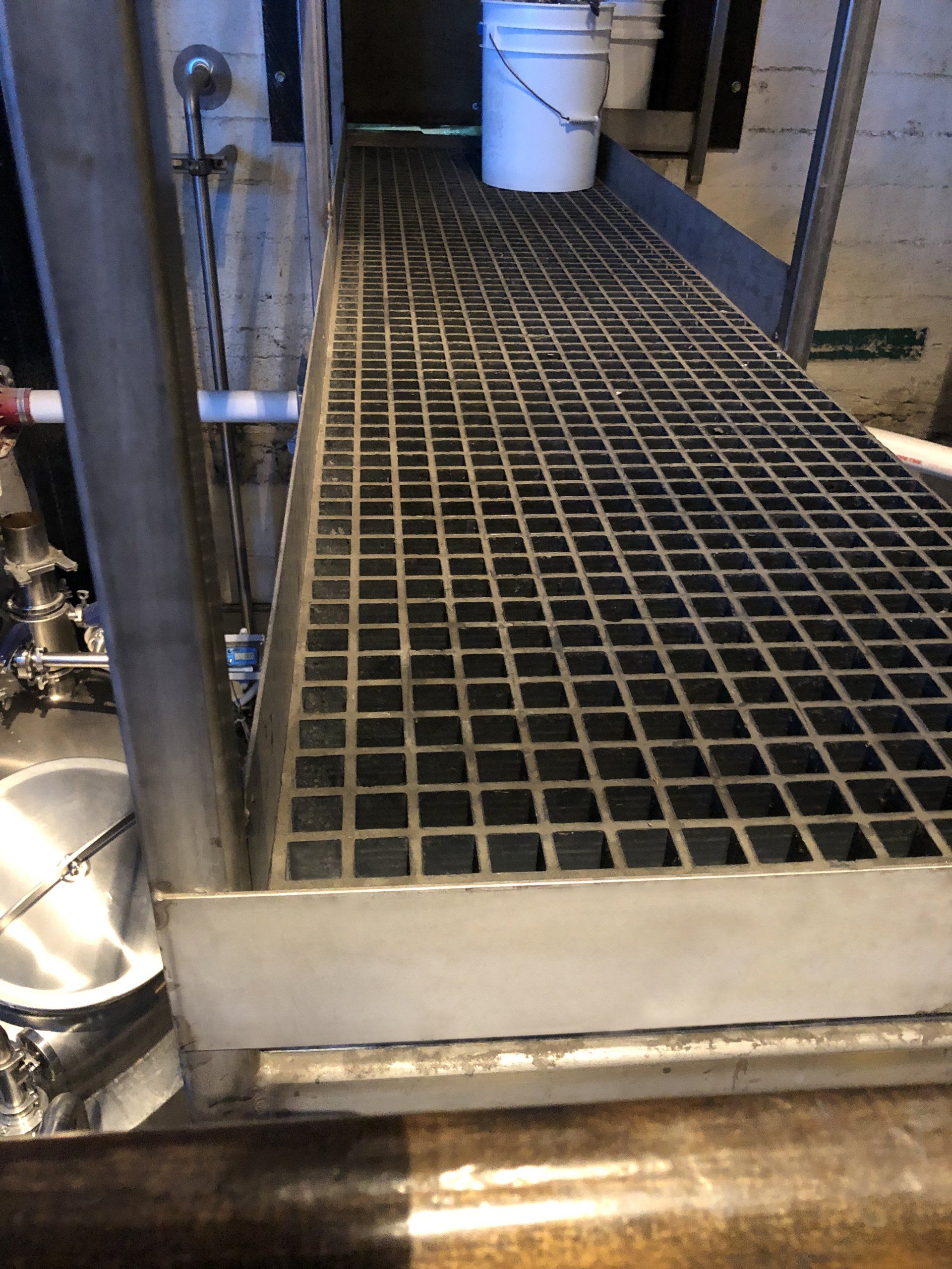 metal frame holding walkway brewery equipment