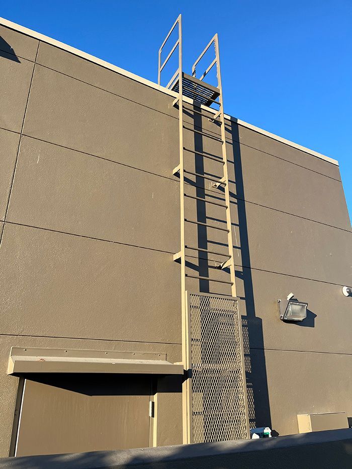 ladder with security door at bottom, allowing access to HVAC roof top unit