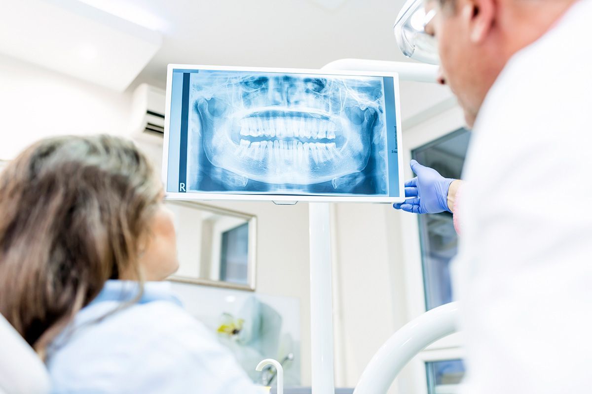 Photo of Dentist Showing Patient X-Ray — Pinetop, AZ — Blue Ridge Family Dentistry PC