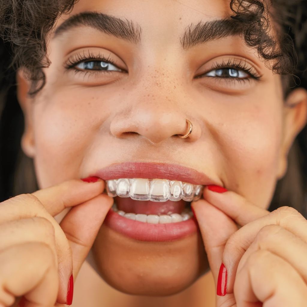 Man with brown hair, beard, and a bright smile wearing a gray t-shirt.
