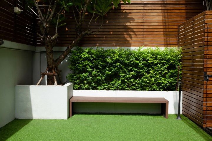 Creative space with astro turf and grass growing from the walls. 