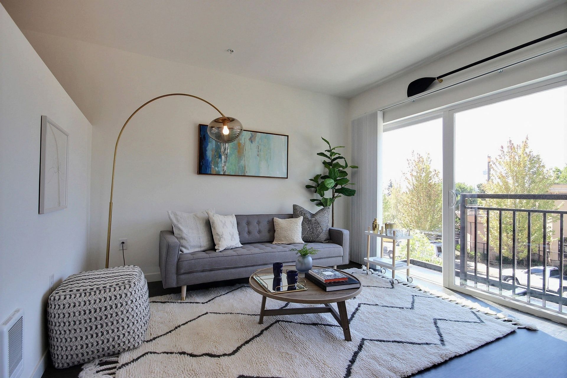 A living room with a couch and a coffee table at CREW Apartments in Seattle, WA.