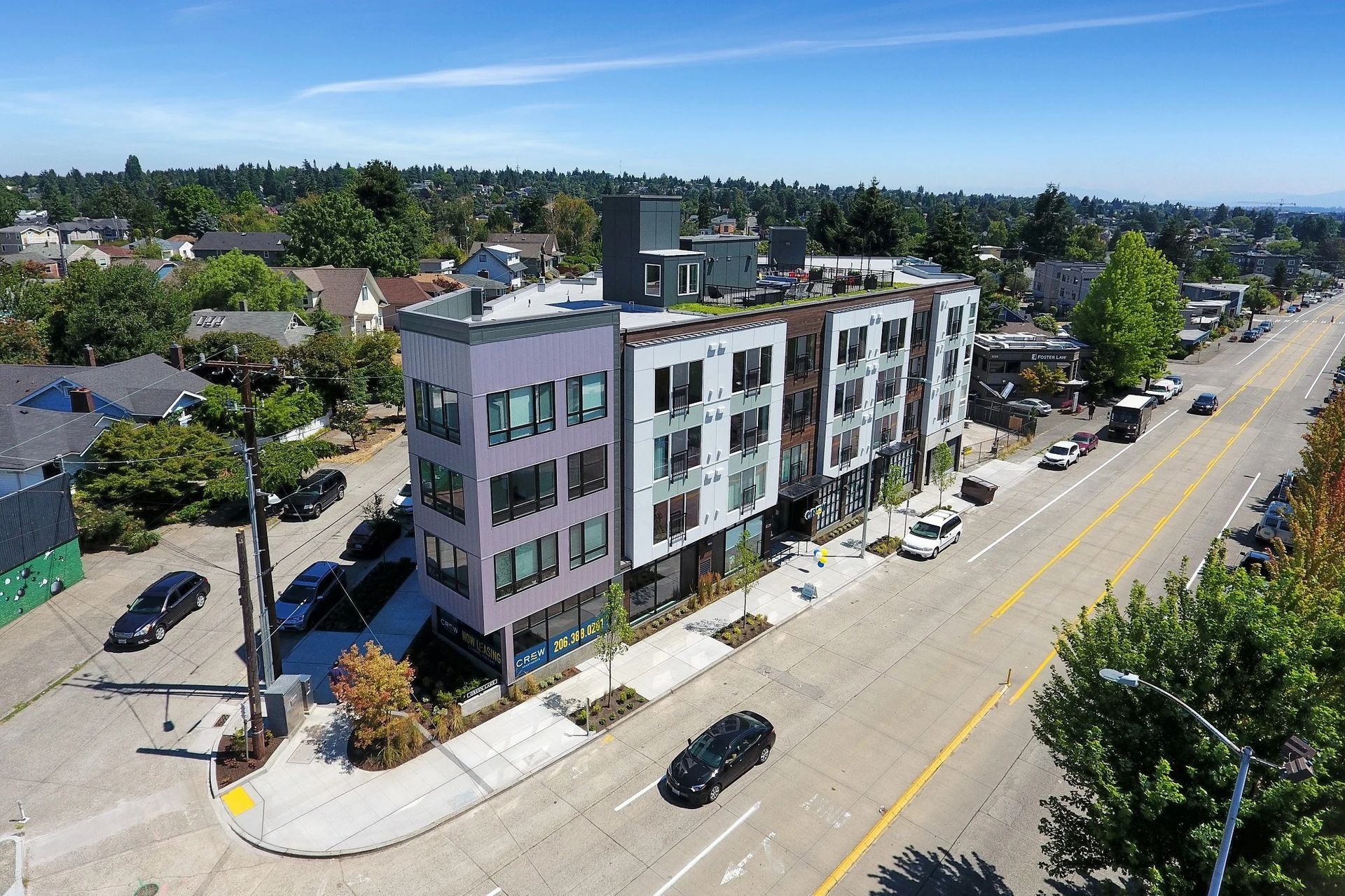 An aerial view of a building along a city street at CREW Apartments in Seattle, WA.