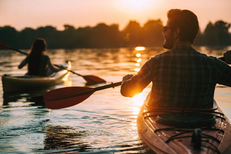 A group of people are rowing boats on a lake.